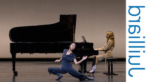 dancer performing in front of a piano